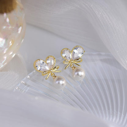 Boucles d'oreilles pendantes en forme de cœur avec nœud en cristal et perles