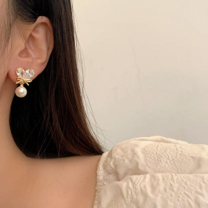 Boucles d'oreilles pendantes en forme de cœur avec nœud en cristal et perles