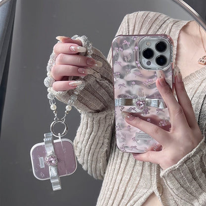 Étui AirPods avec accessoires et nœud papillon rose